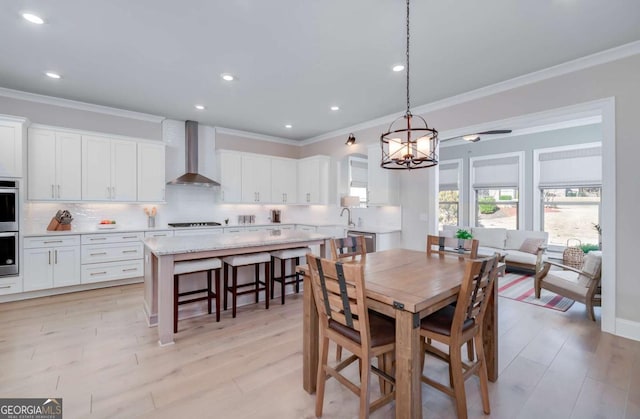 dining room featuring sink, crown molding, and a chandelier