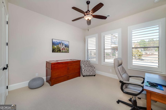 carpeted home office with ceiling fan