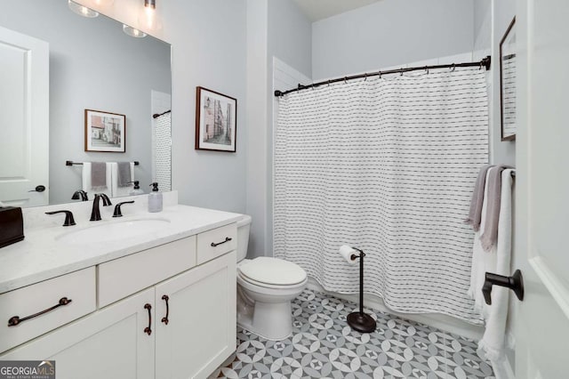 bathroom with toilet, vanity, and walk in shower