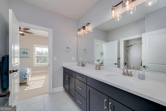 bathroom featuring ceiling fan, walk in shower, vanity, and tile patterned flooring