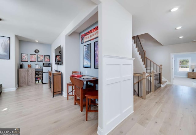 hallway with light hardwood / wood-style flooring