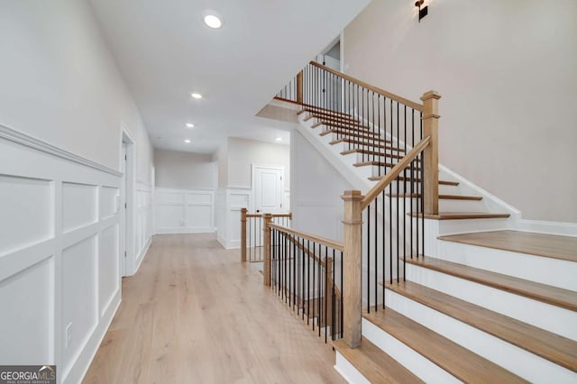 stairs with hardwood / wood-style floors