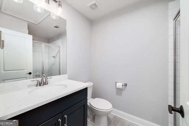 bathroom featuring toilet, a shower with shower door, hardwood / wood-style flooring, and vanity