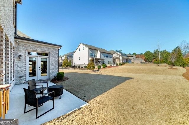 view of yard featuring a patio area and french doors