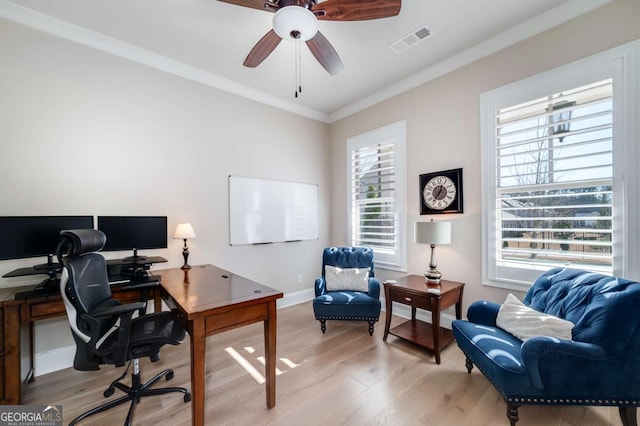 office area featuring light wood-type flooring, ceiling fan, and crown molding