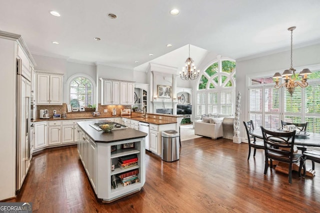 kitchen featuring a kitchen island, pendant lighting, white cabinets, and plenty of natural light