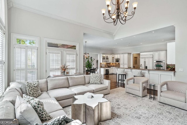 tiled living room featuring ornamental molding, lofted ceiling, and a notable chandelier