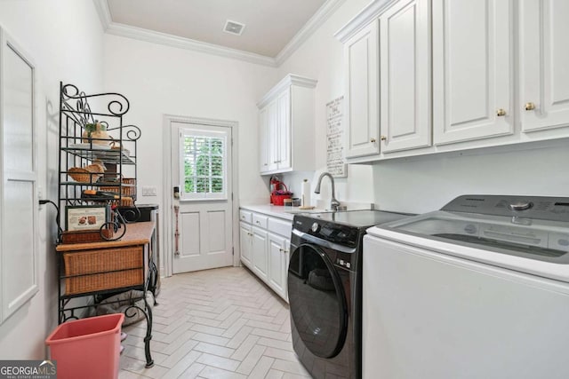 laundry room with cabinets, ornamental molding, washing machine and clothes dryer, and sink