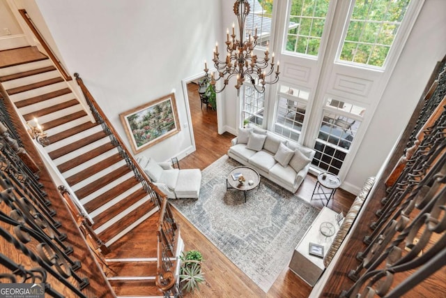 living room with hardwood / wood-style floors and a chandelier