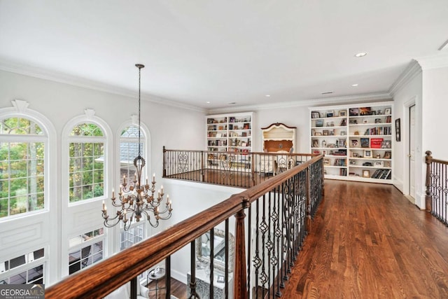 hallway with an inviting chandelier, dark hardwood / wood-style flooring, and crown molding