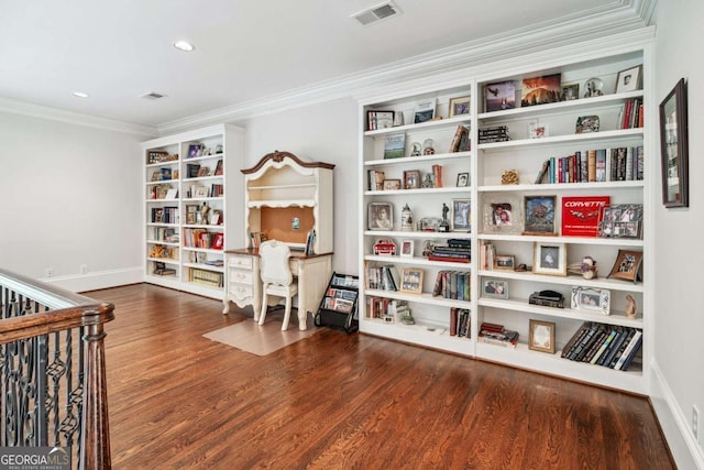 living area with hardwood / wood-style flooring and crown molding