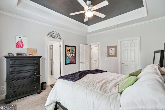 bedroom featuring a raised ceiling, light colored carpet, ceiling fan, and crown molding