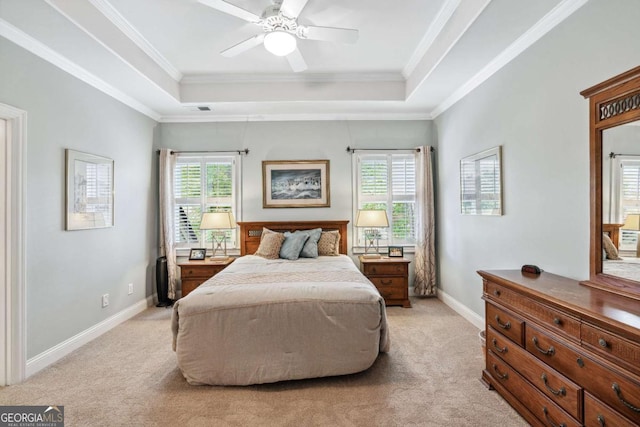 bedroom featuring ceiling fan, light colored carpet, a raised ceiling, and multiple windows