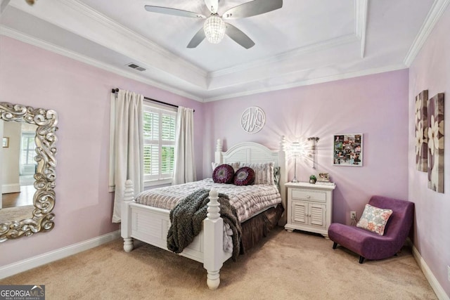 bedroom with ceiling fan, light colored carpet, and a tray ceiling