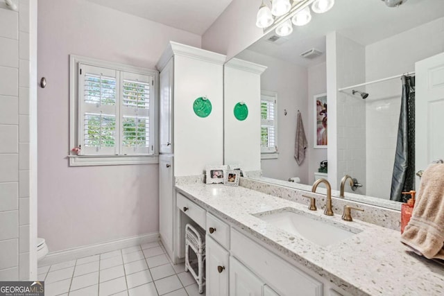 bathroom featuring toilet, vanity, a shower with shower curtain, and tile patterned flooring