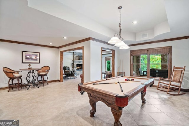 rec room featuring light tile patterned floors, billiards, crown molding, and a stone fireplace