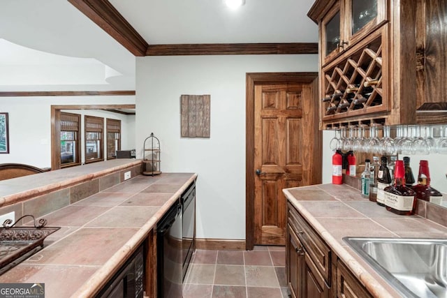 kitchen with crown molding, sink, tile countertops, and black dishwasher