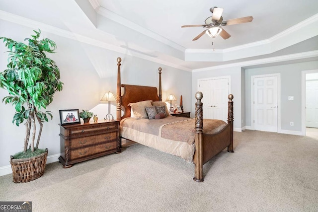 carpeted bedroom featuring ceiling fan, crown molding, and a raised ceiling