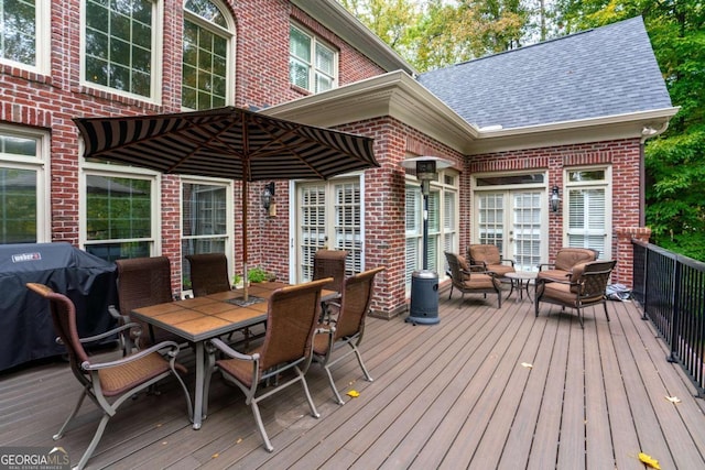 wooden deck with outdoor lounge area and a grill