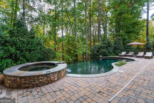 view of pool with an in ground hot tub and a patio