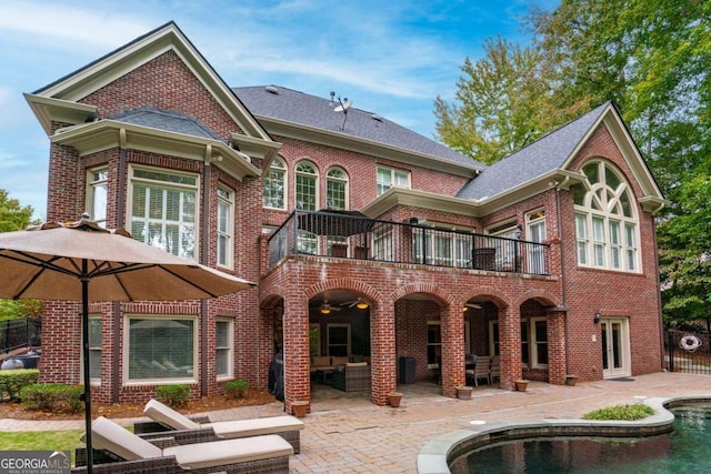 rear view of house with a balcony and a patio area