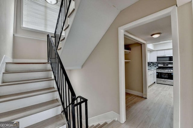 staircase featuring hardwood / wood-style floors