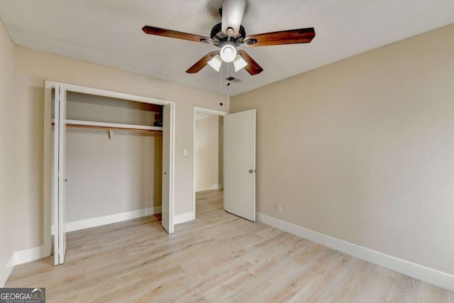 unfurnished bedroom featuring ceiling fan, a closet, and light hardwood / wood-style floors