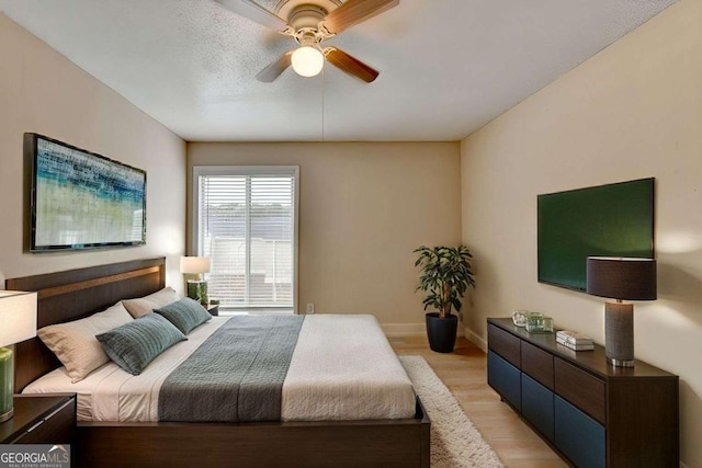 bedroom with ceiling fan and light hardwood / wood-style floors