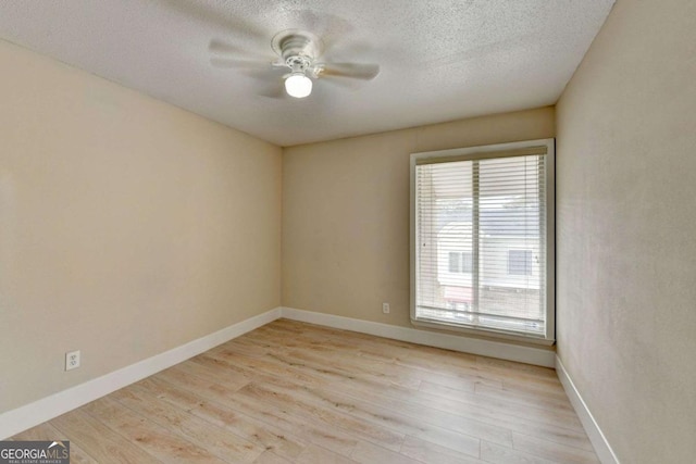 empty room with ceiling fan, a textured ceiling, and light hardwood / wood-style floors