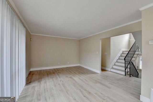 unfurnished living room featuring light wood-type flooring and ornamental molding