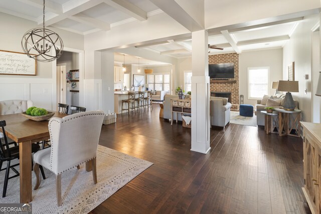 living room with dark wood-type flooring, beamed ceiling, sink, ceiling fan, and coffered ceiling