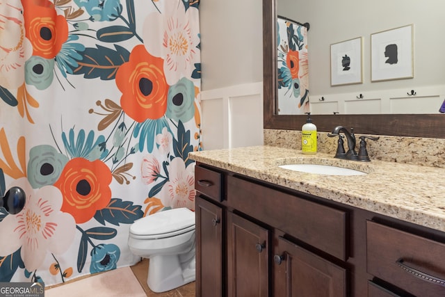 bathroom with toilet, tile patterned floors, and vanity