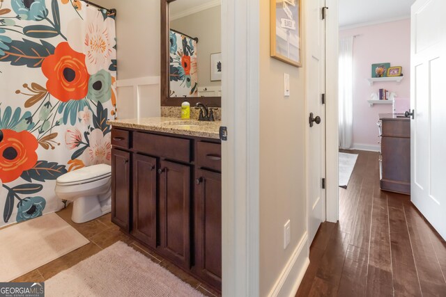 bedroom with dark hardwood / wood-style floors, crown molding, and a tray ceiling