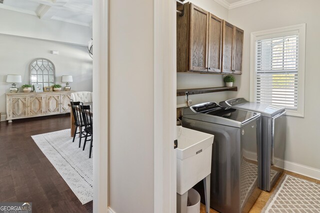 laundry area with washer and dryer, sink, and cabinets