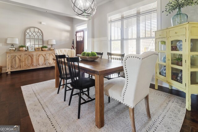 dining room featuring dark wood-type flooring and beam ceiling