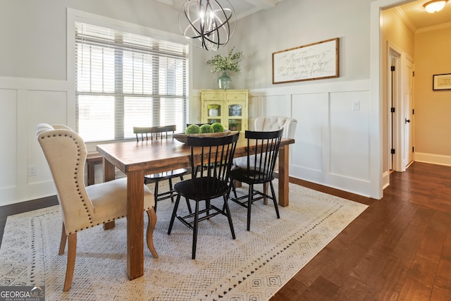 dining area featuring dark hardwood / wood-style floors, ornamental molding, and an inviting chandelier