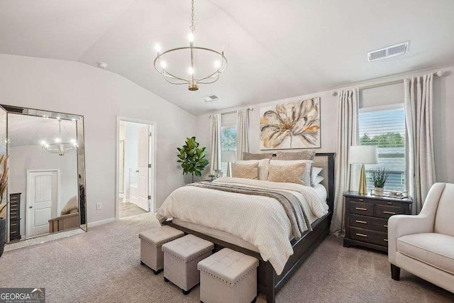 bedroom featuring ensuite bathroom, carpet floors, and multiple windows