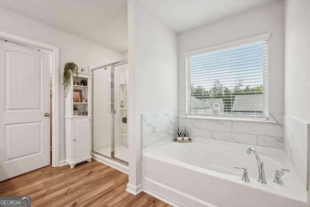 bathroom with plus walk in shower and wood-type flooring