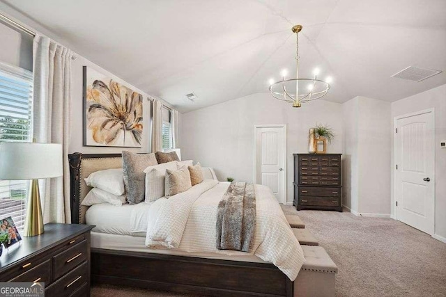 carpeted bedroom with multiple windows, lofted ceiling, and a notable chandelier