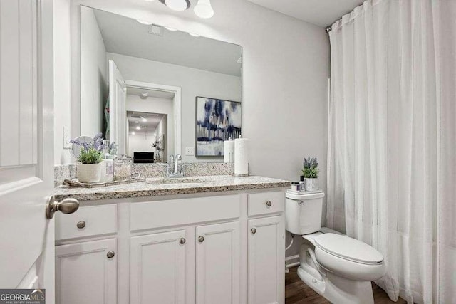 bathroom featuring toilet and vanity