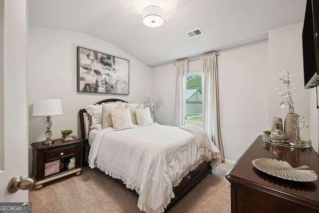 bedroom featuring lofted ceiling and carpet floors