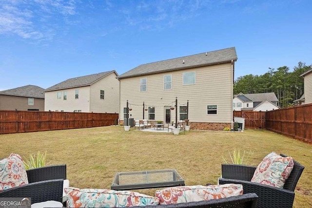 back of house with a yard and a patio