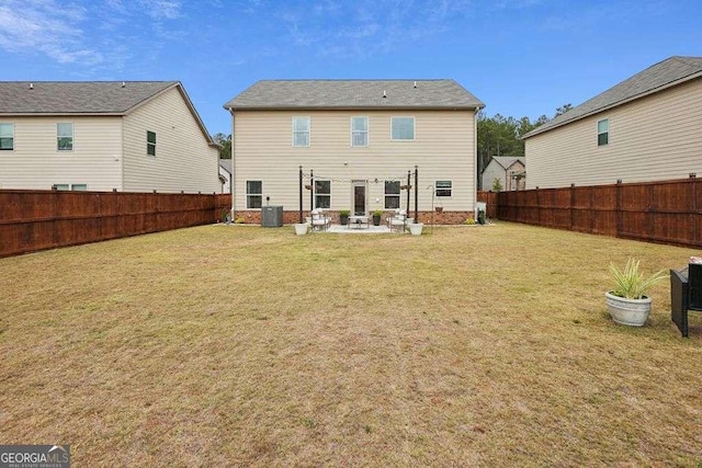 rear view of house with a patio area, central AC unit, and a lawn