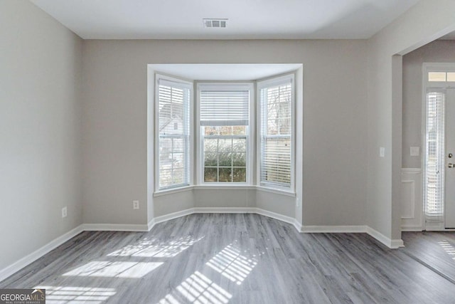 empty room with light hardwood / wood-style floors