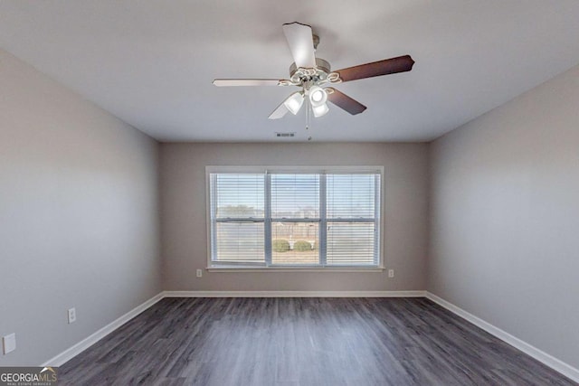 unfurnished room featuring ceiling fan and dark hardwood / wood-style flooring