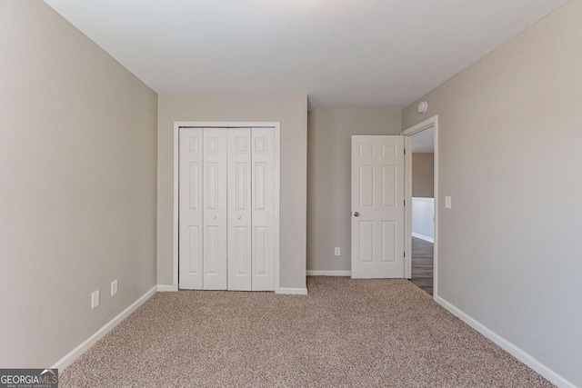 unfurnished bedroom featuring a closet and carpet flooring