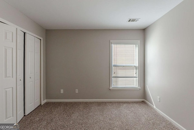 unfurnished bedroom featuring a closet and carpet flooring