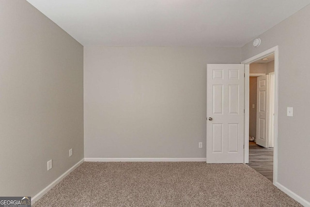 unfurnished room featuring carpet