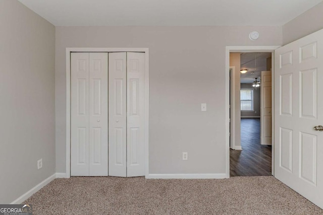 unfurnished bedroom with a closet and carpet flooring