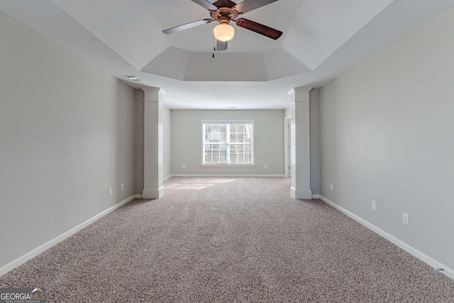 unfurnished room featuring ceiling fan, carpet, and a tray ceiling